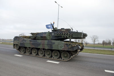 View of vehicles on road against sky