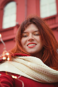 Close up attractive lady with knitted scarf and lights portrait picture