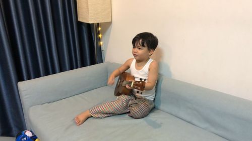 Boy playing piano at home