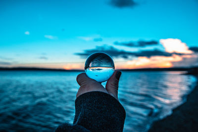 Lensball in golden hour over the water against the sky