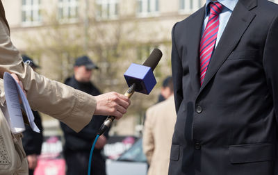 Close-up of hands holding camera