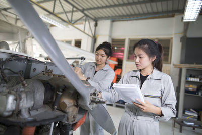 Workers making air vehicle in workshop