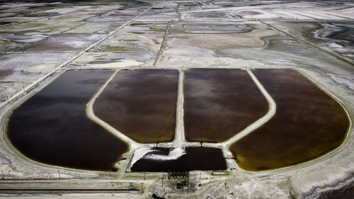 High angle view of wet footpath by lake during winter