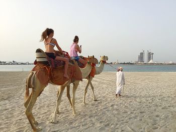 Rear view of woman sitting by river