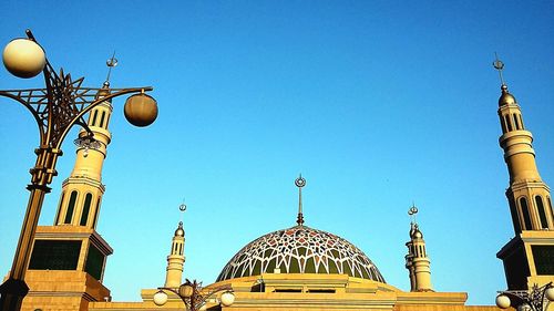 Low angle view of built structure against clear blue sky