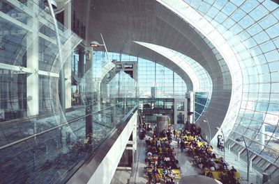 High angle view of passengers sitting in waiting room at airport
