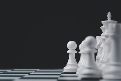 Close-up of chess pieces against black background