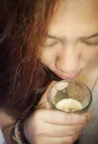 Close-up portrait of a woman drinking drink