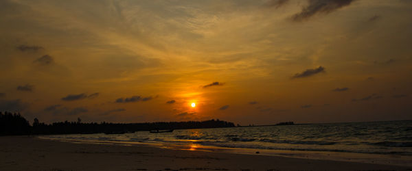 Scenic view of beach against sky during sunset