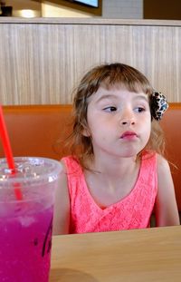 Portrait of cute girl sitting on table