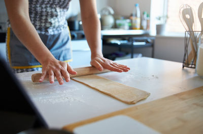 Midsection of woman preparing food at home