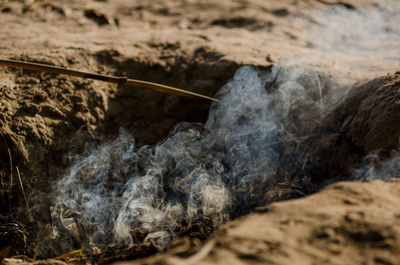 Close-up of smoke emitting from land