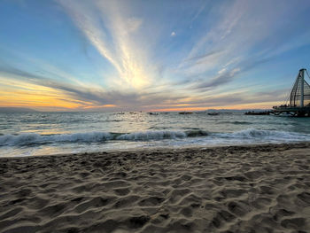 Scenic view of beach against sky during sunset