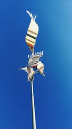 Low angle view of bird against clear blue sky