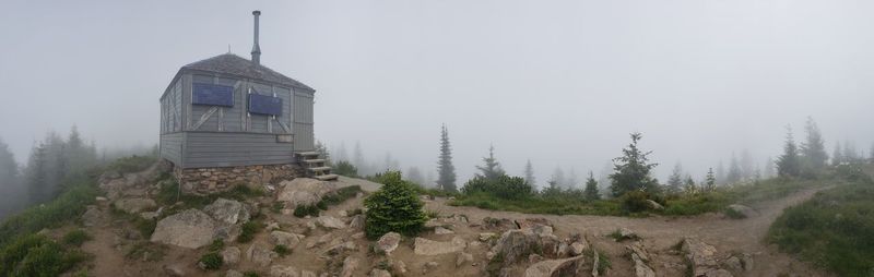 Panoramic shot of building and trees against sky