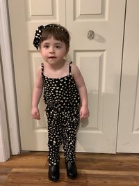 Portrait of cute girl standing at home