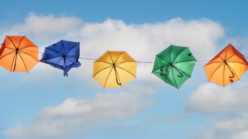Low angle view of colorful umbrella against sky