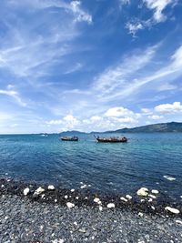 Scenic view of sea against blue sky