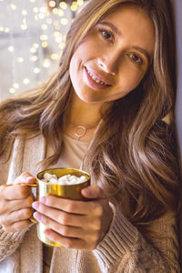 Portrait of young woman having drink