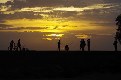 Silhouette of people at beach 