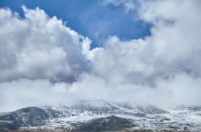 Scenic view of sea and mountains against sky