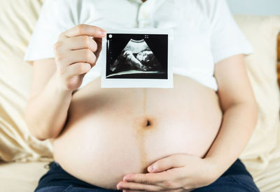Midsection of woman holding hands