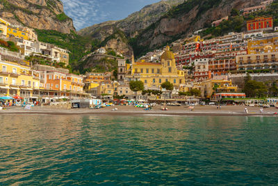 Sea by houses on mountain