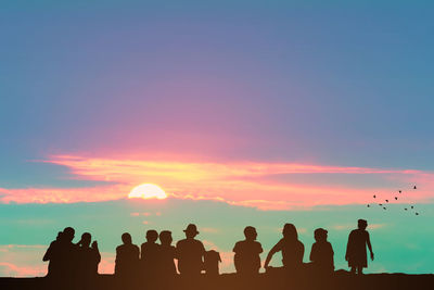 Silhouette people at sunset
