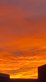 Silhouette of building against dramatic sky