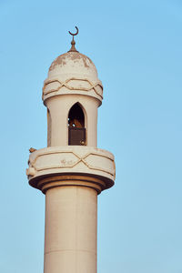Low angle view of lighthouse against clear blue sky