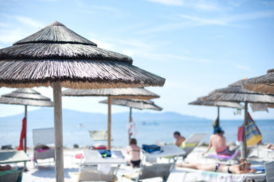 Scenic view of beach umbrellas against blue sky