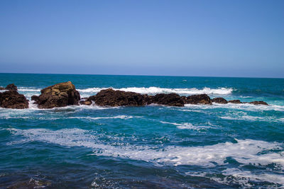 Scenic view of sea against clear blue sky