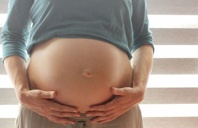 Midsection of woman touching hair