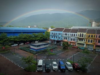 High angle view of rainbow over buildings in city