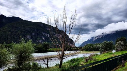 Scenic view of mountains against cloudy sky