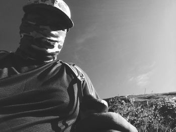 Low angle view of man on field against sky