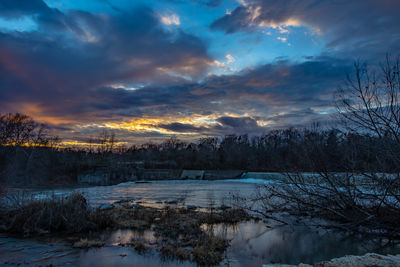 Scenic view of snow covered landscape against sky during sunset