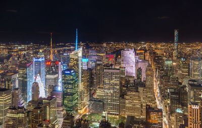 Aerial view of city lit up at night