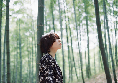 Side view of woman in forest