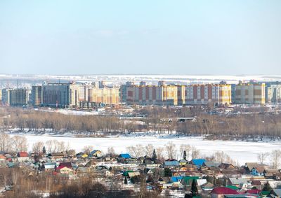 High angle view of buildings and city against sky