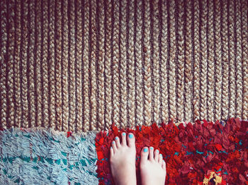 Low section of woman legs on rug