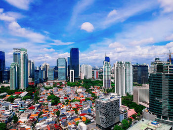 High angle view of modern buildings in city against sky