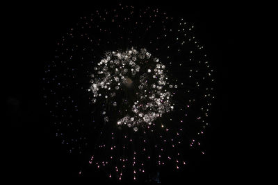 Firework display over black background