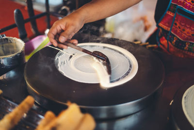 Midsection of person preparing food at market stall