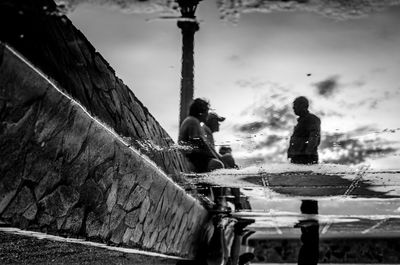 Upside down image of people reflection in puddle