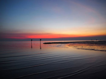 Scenic view of sea against romantic sky at sunset