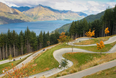 Scenic view of lake by mountains against sky