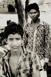 Portrait of young couple standing outdoors