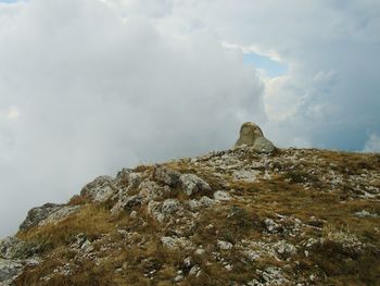 Low angle view of rock formation against sky