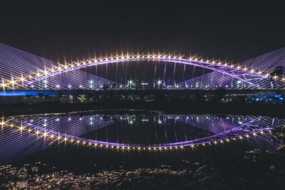 Illuminated bridge at night